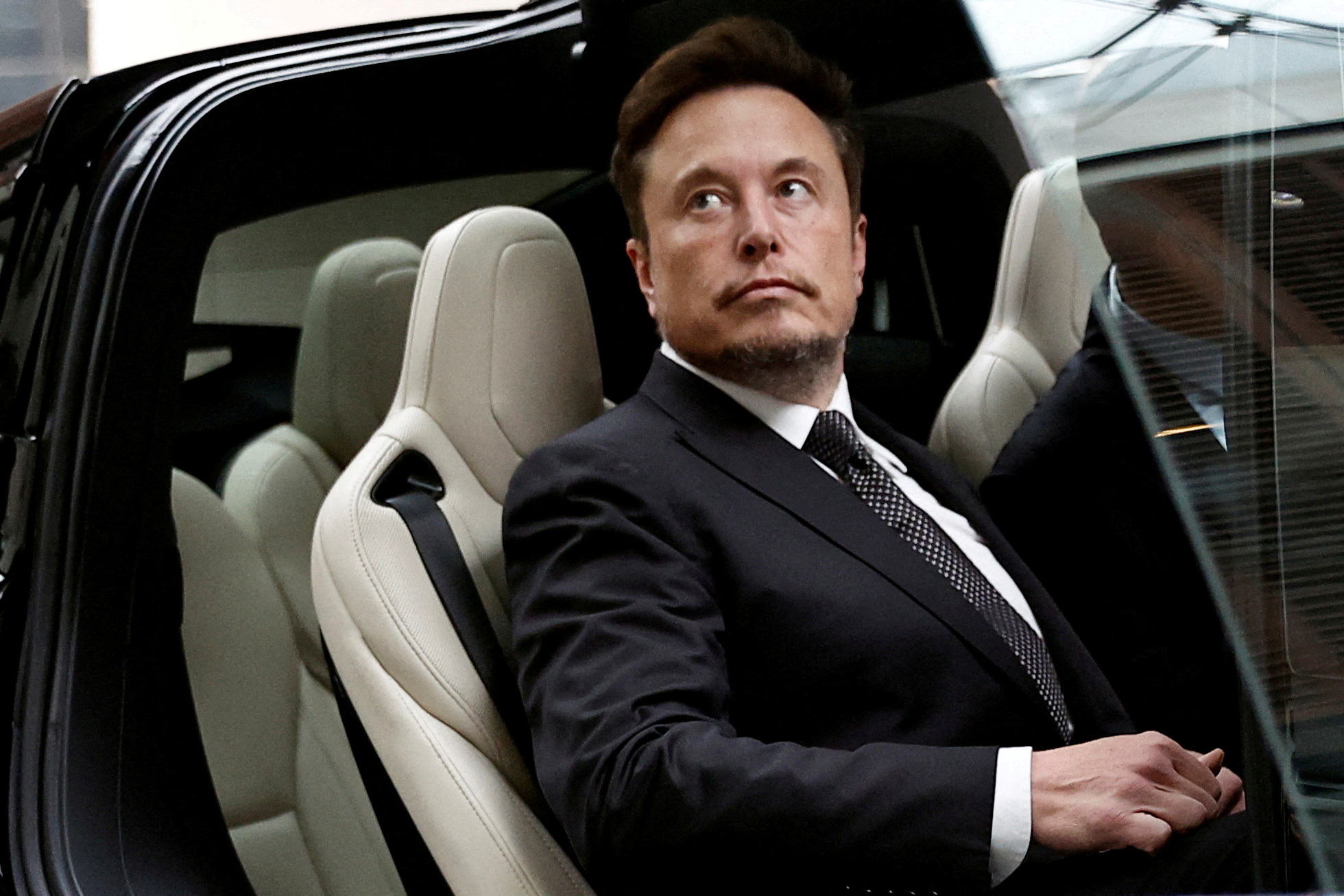 Musk in a Tesla. A large part of his $200 billion net worth is wrapped up in the company’s stock